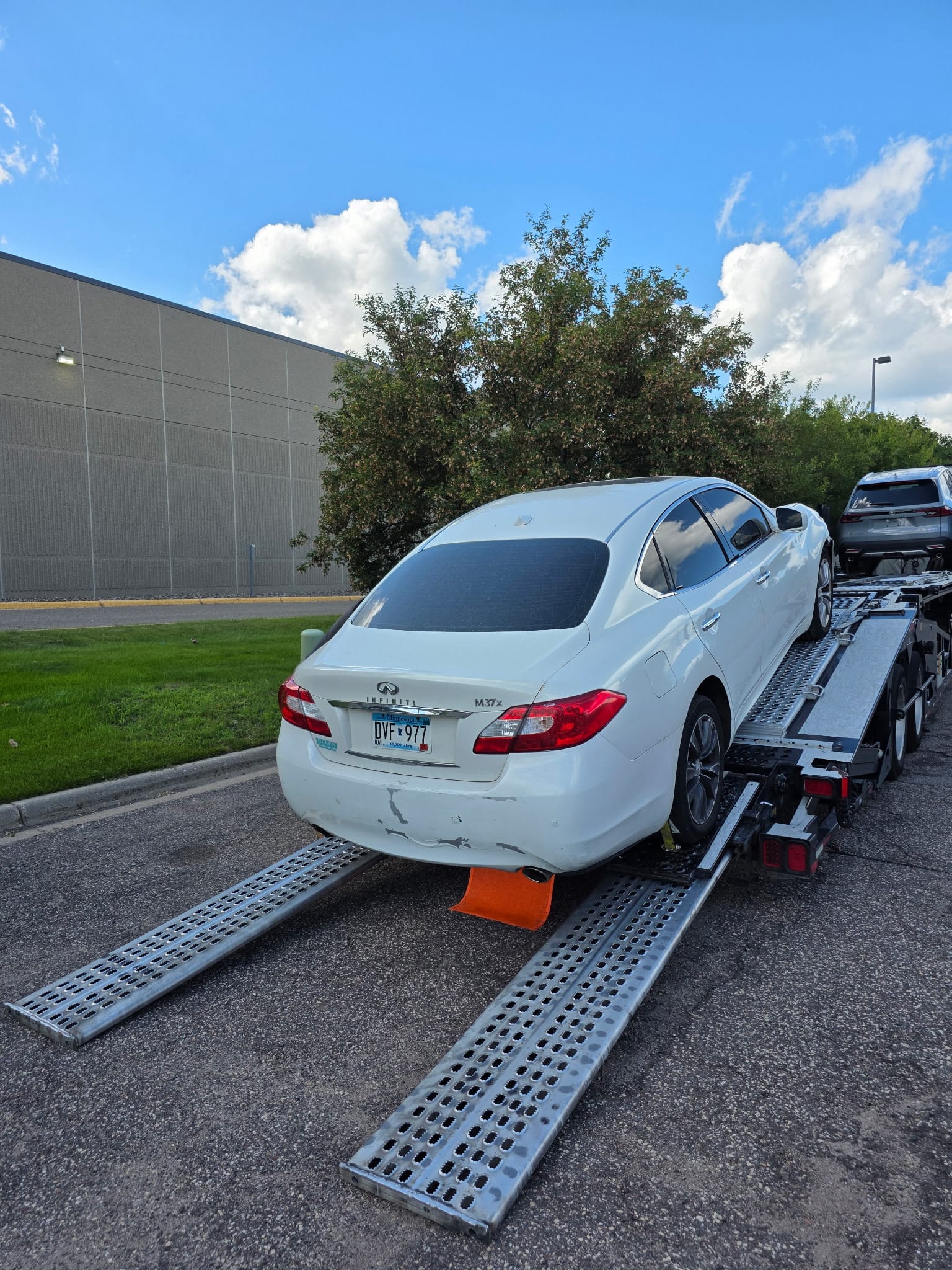 Flatbed tow truck loading a vehicle on a residential street in St Paul, Minnesota